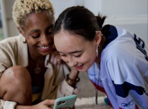 Two young women looking at a phone